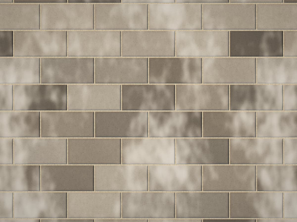 Charcoal pavers with patches of white efflorescence haze.