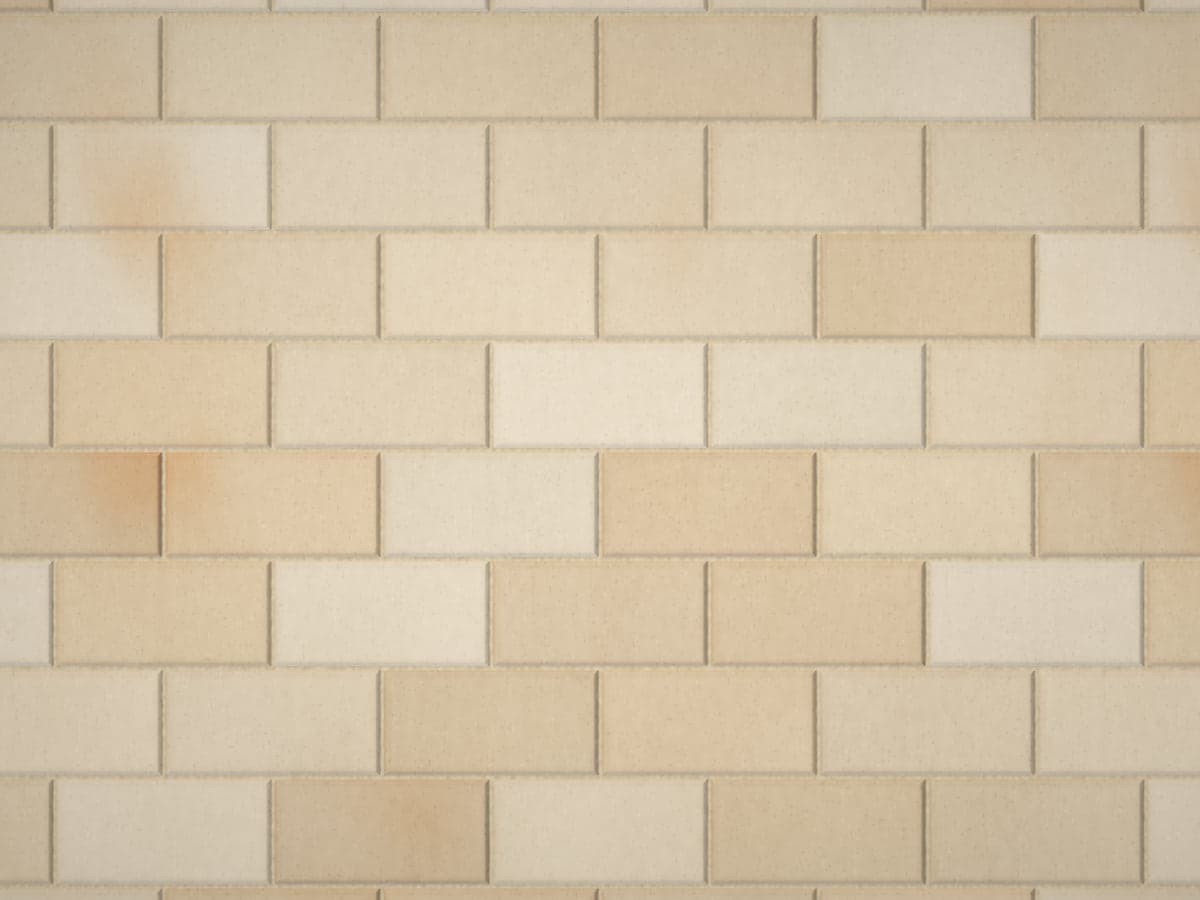 Light pavers with orange rust-colored staining in curved patches.