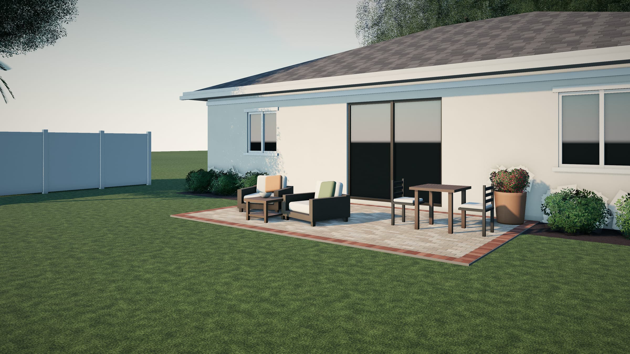 Modest paver patio with a terracotta border outside a sliding door, with two lounge chairs, a small bistro table, and a white vinyl privacy fence.